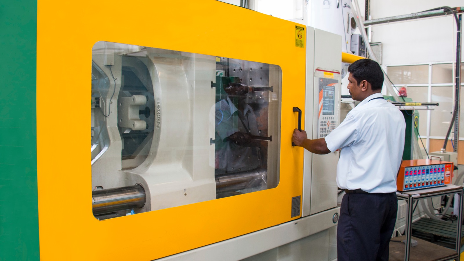 Operator at a 450-tonne injection moulding machine at TPI